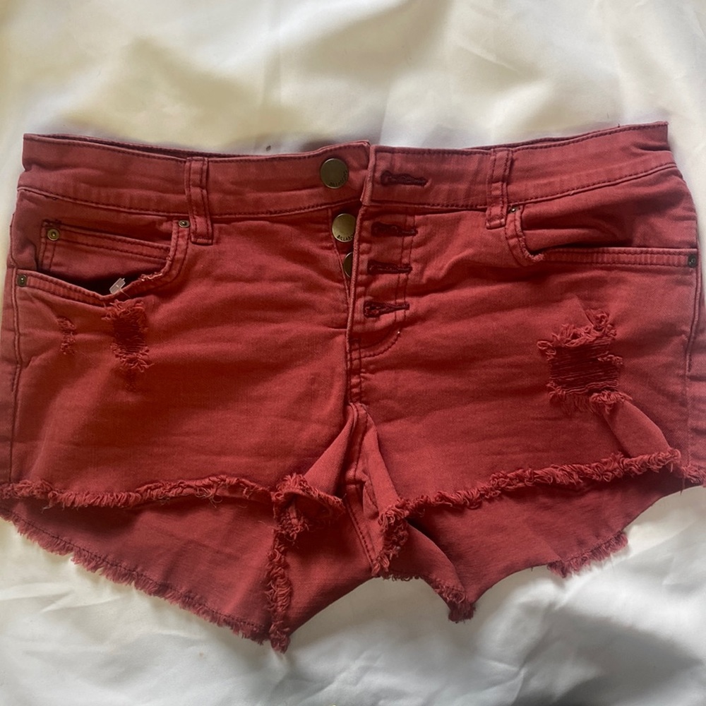 Billabong size 27 color denim distressed button up shorts.